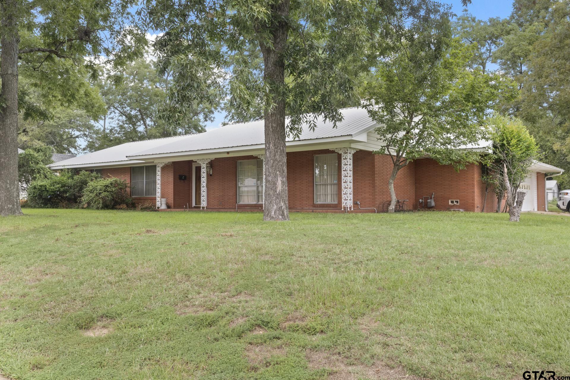 a front view of house with yard and green space