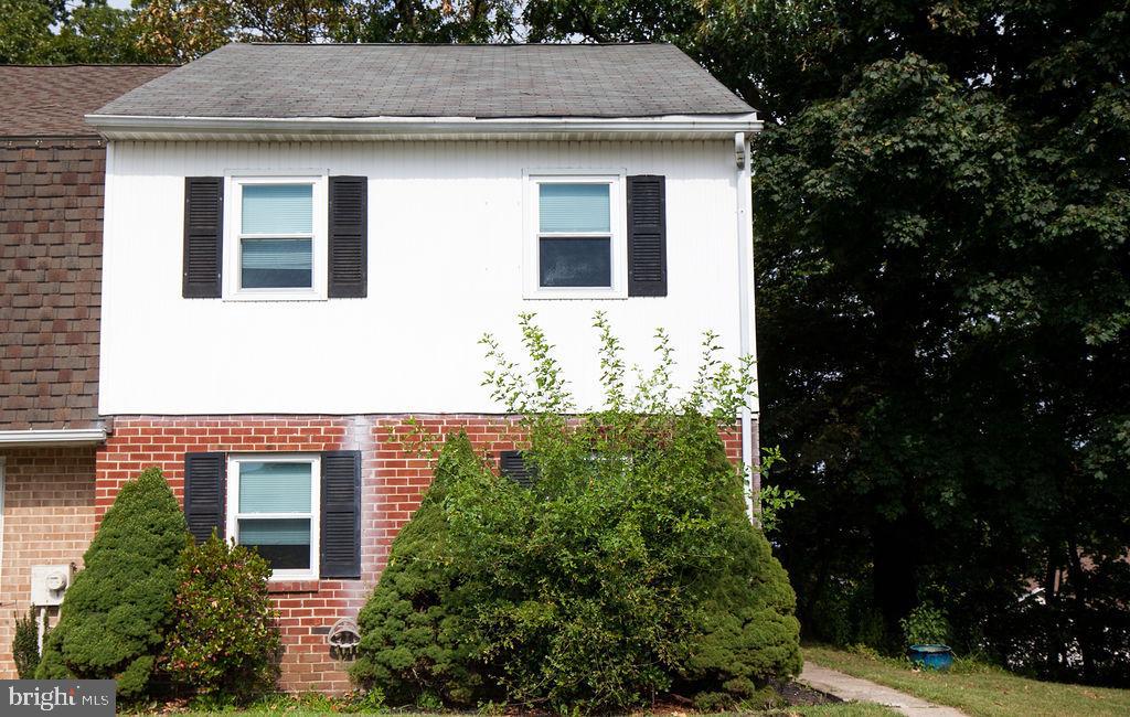 a front view of a house with plants