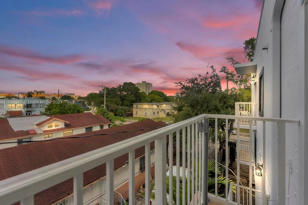 a view of a balcony with wooden floor and city view