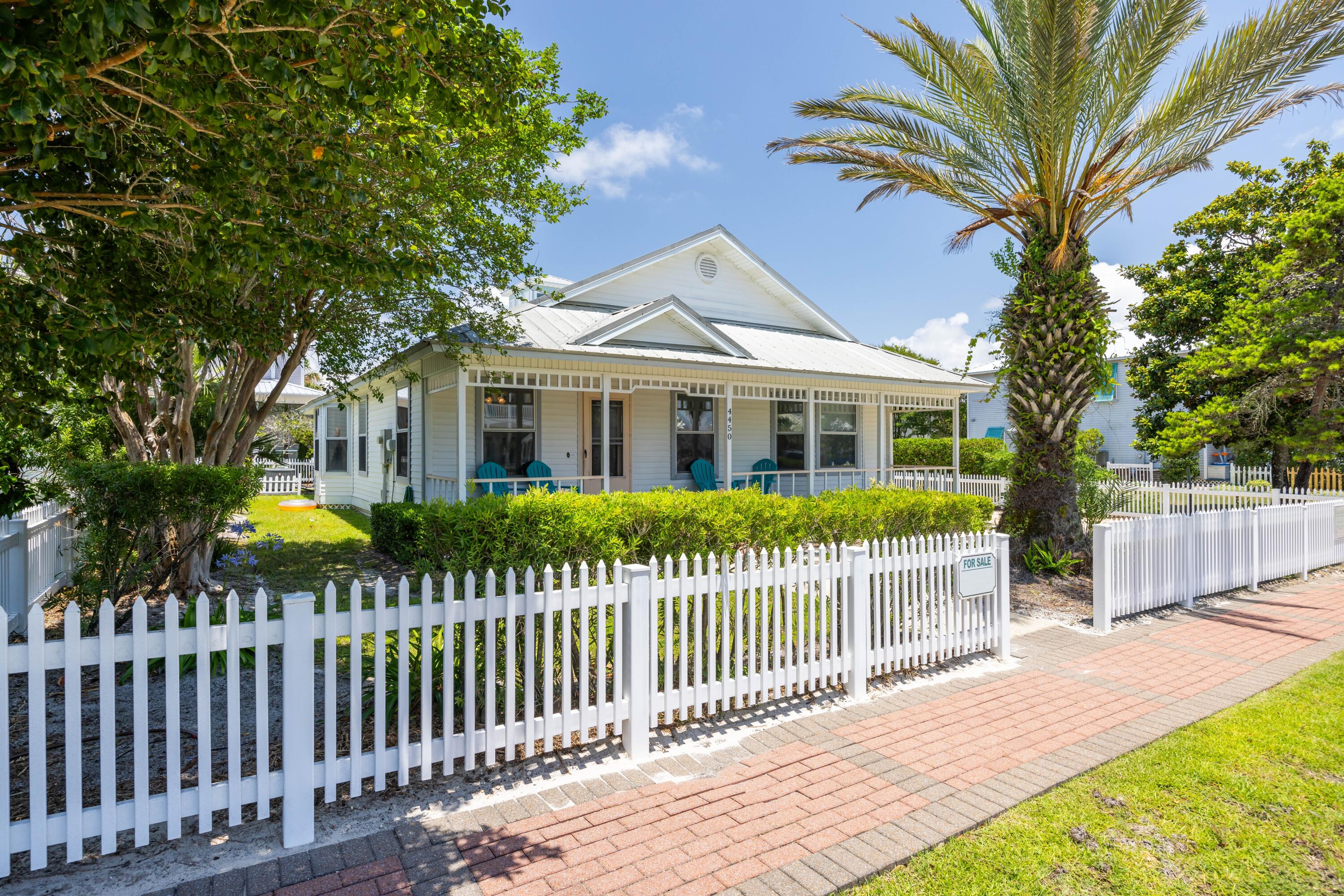 a front view of a house with a garden