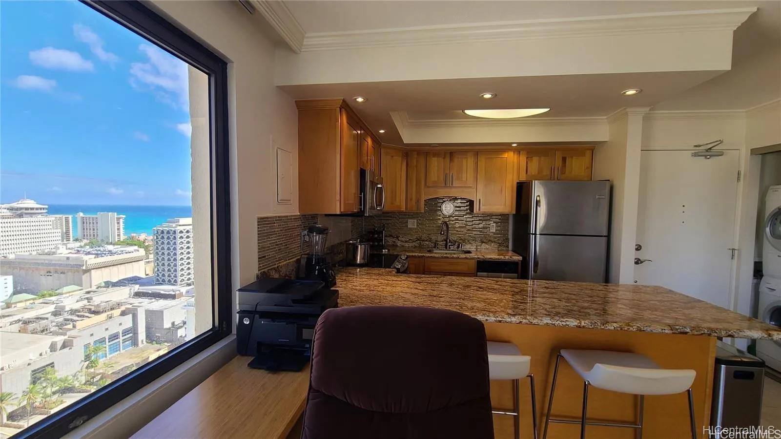 a kitchen with kitchen island granite countertop wooden cabinets and refrigerator