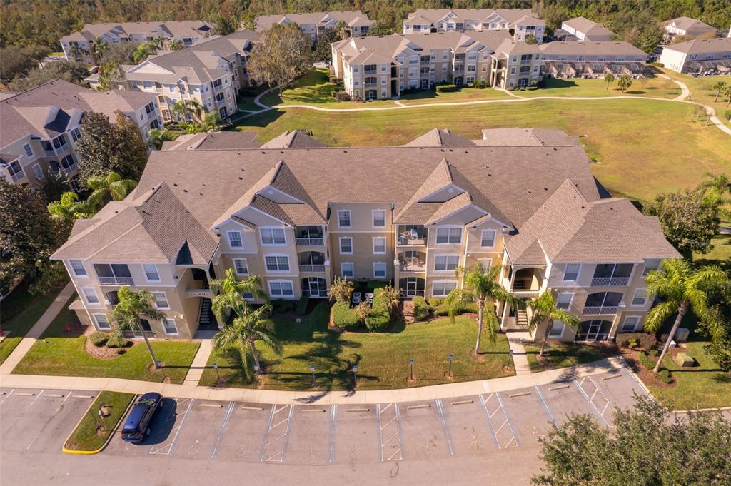 an aerial view of residential houses with outdoor space and swimming pool