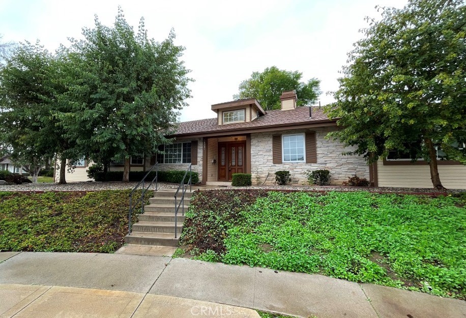 a front view of a house with a garden