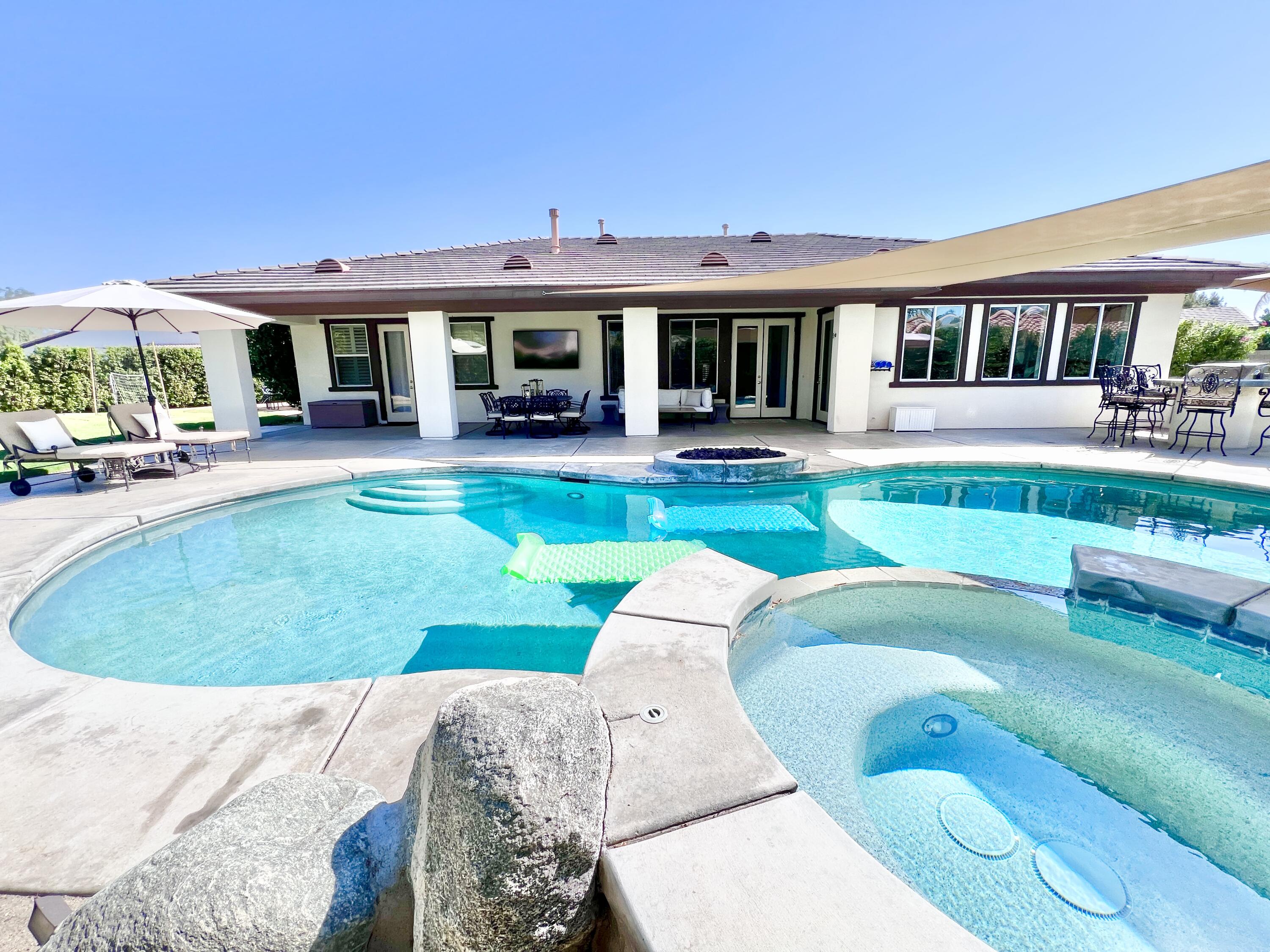 a view of a house with swimming pool and porch