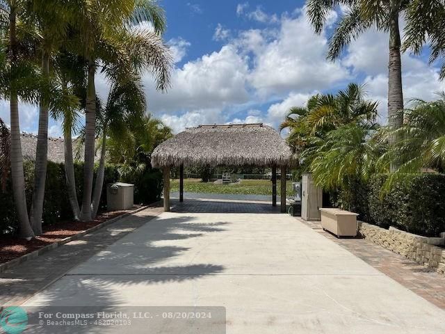 a view of a house with palm trees