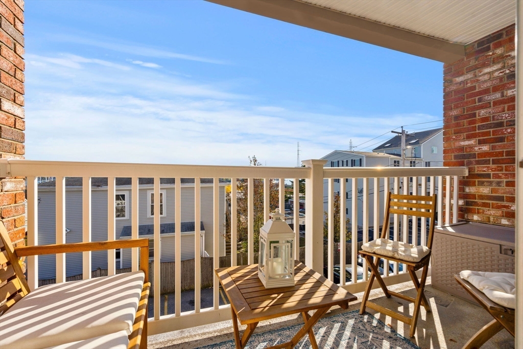 a view of a chairs and table in the balcony