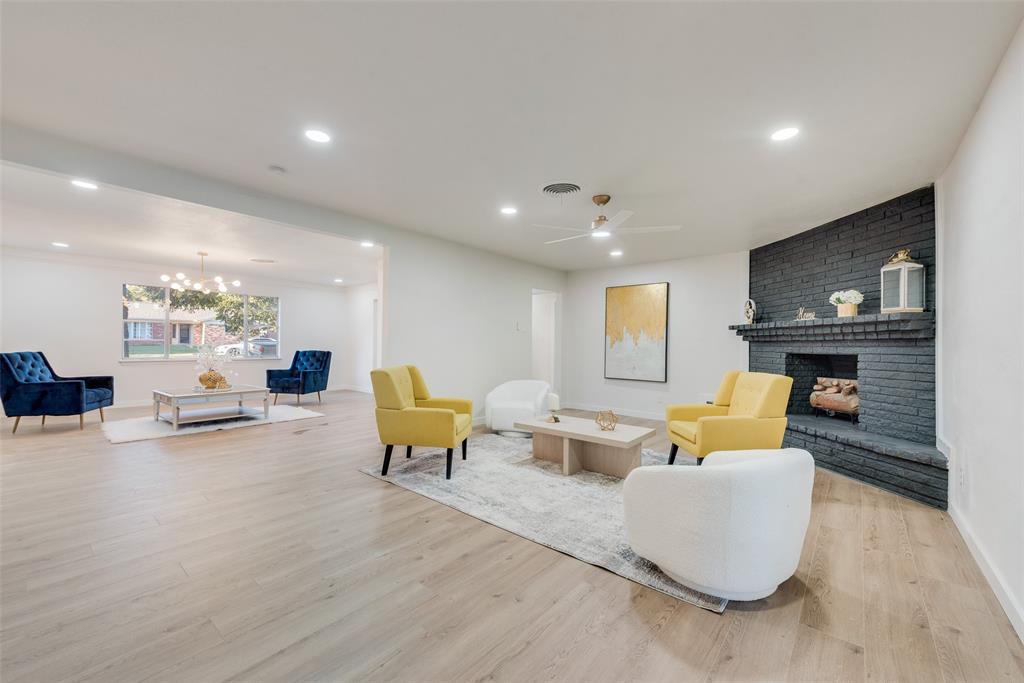 a living room with fireplace furniture and a wooden floor