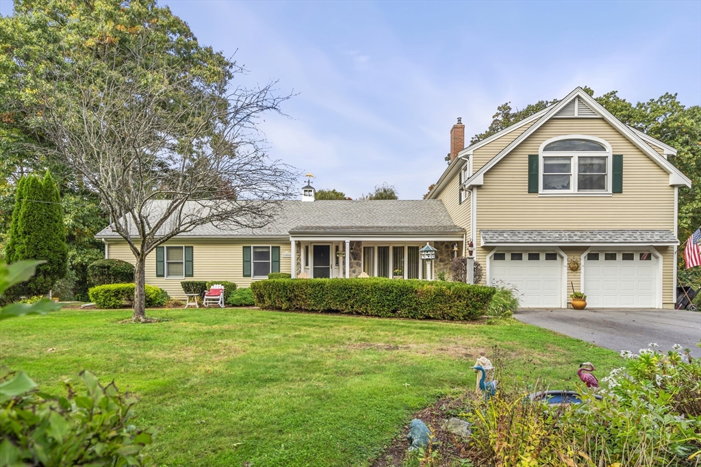 a front view of a house with garden