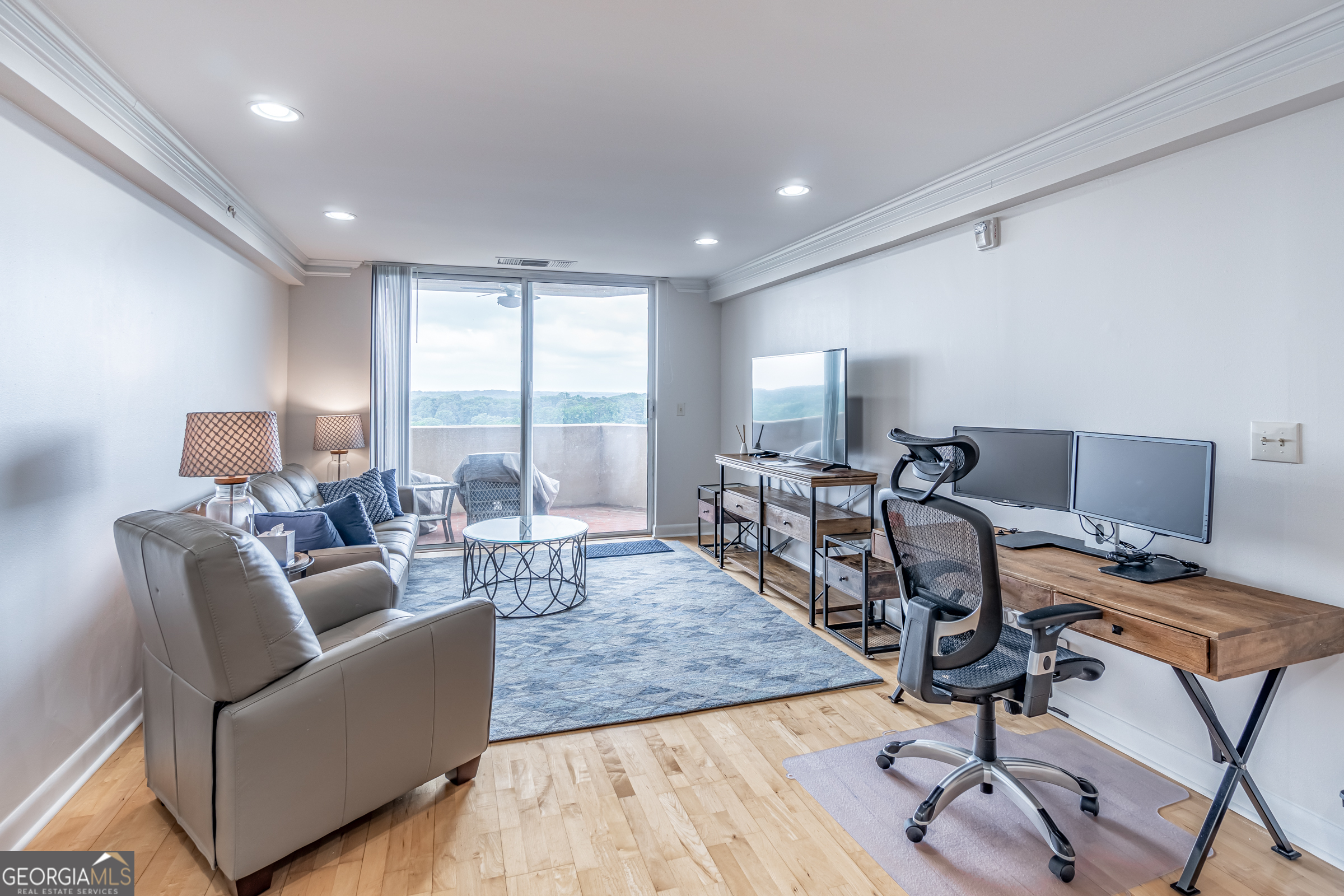 a living room with furniture and a wooden floor