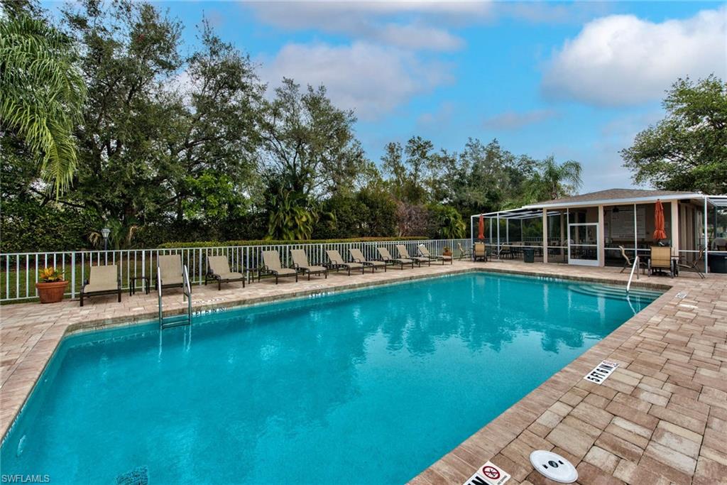 a view of a house with swimming pool and sitting area