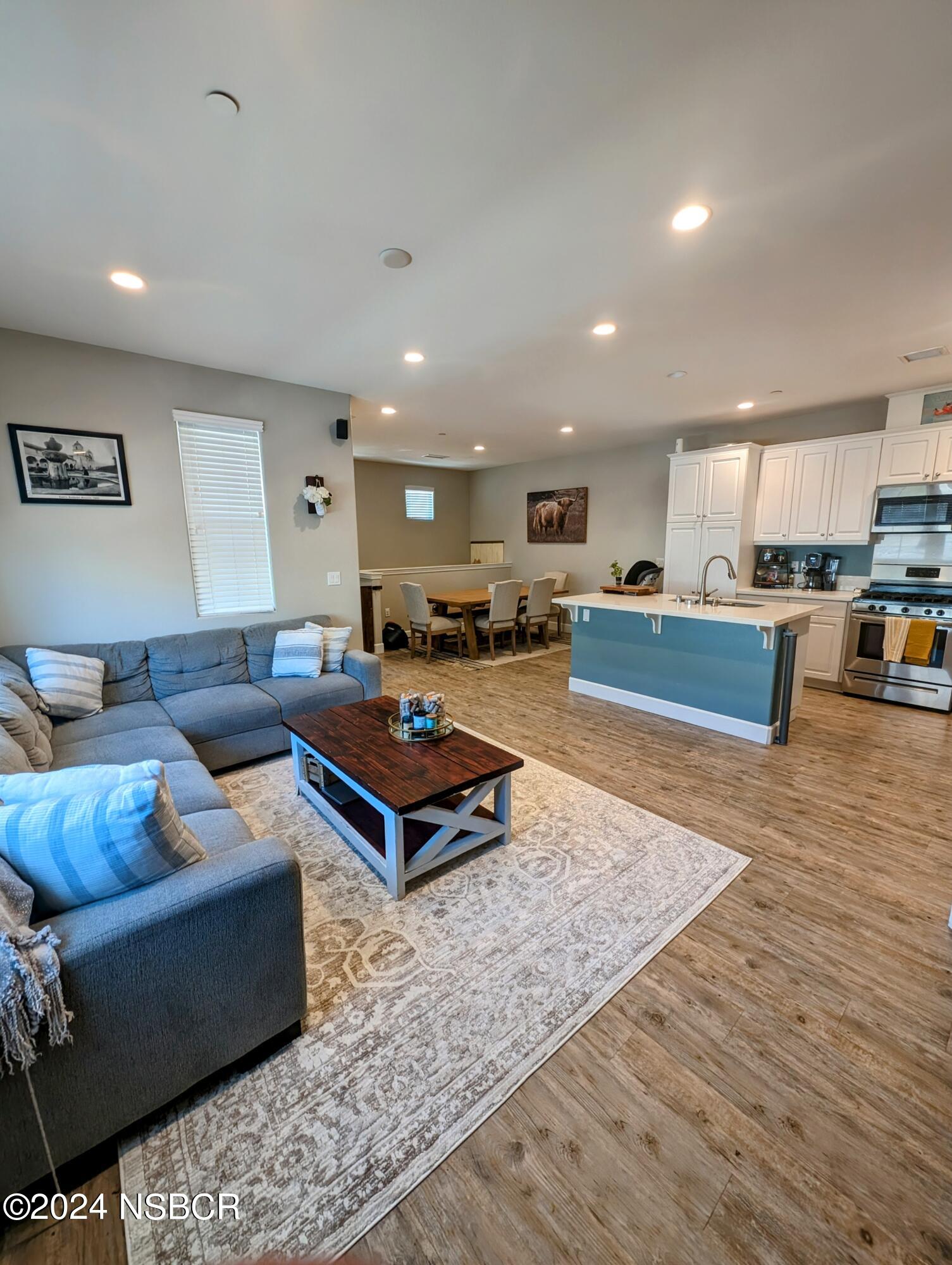 a living room with furniture and kitchen view