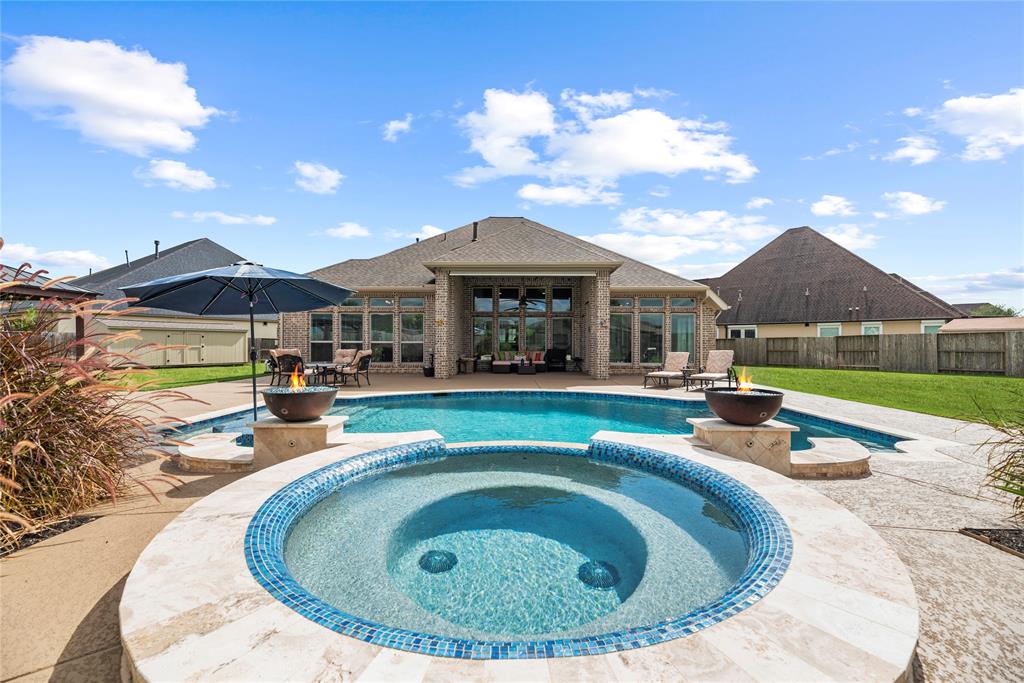 a view of a house with swimming pool and porch