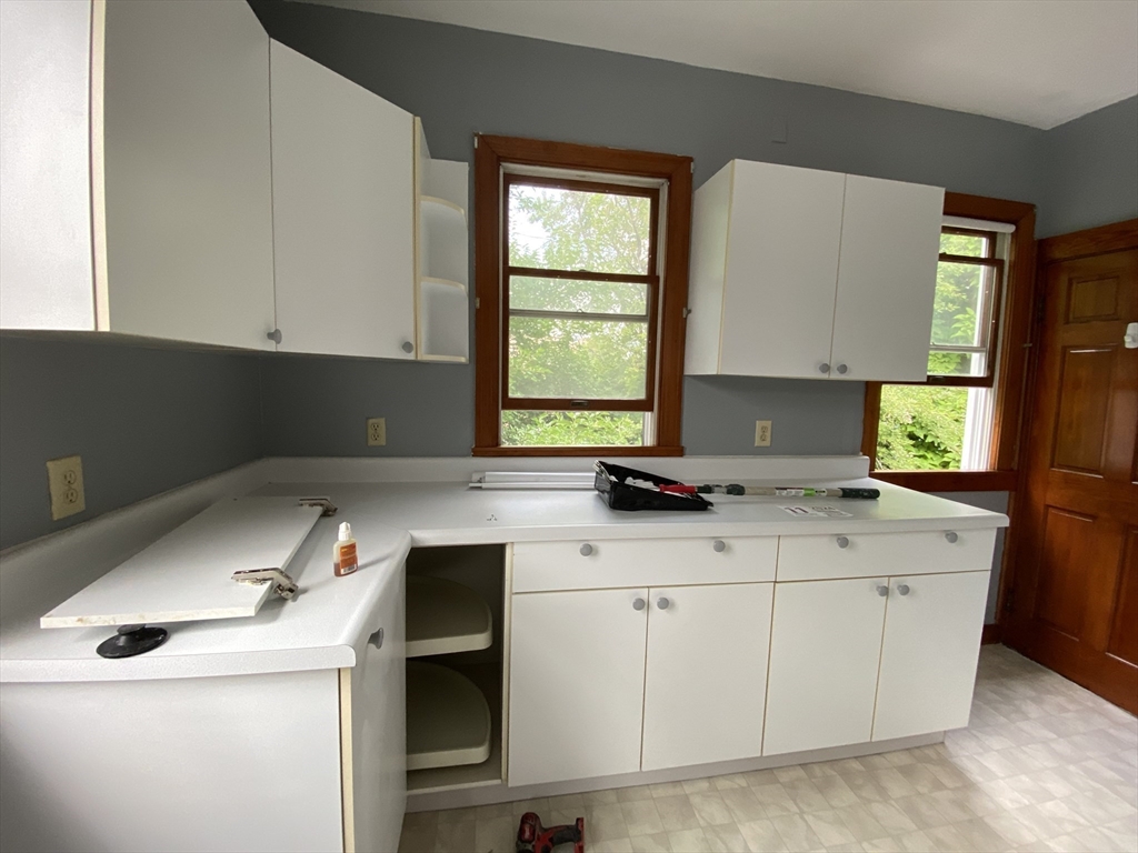 a kitchen with a sink cabinets and window