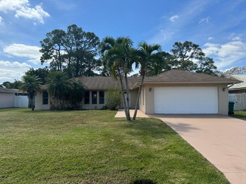 a house that has a tree in front of it