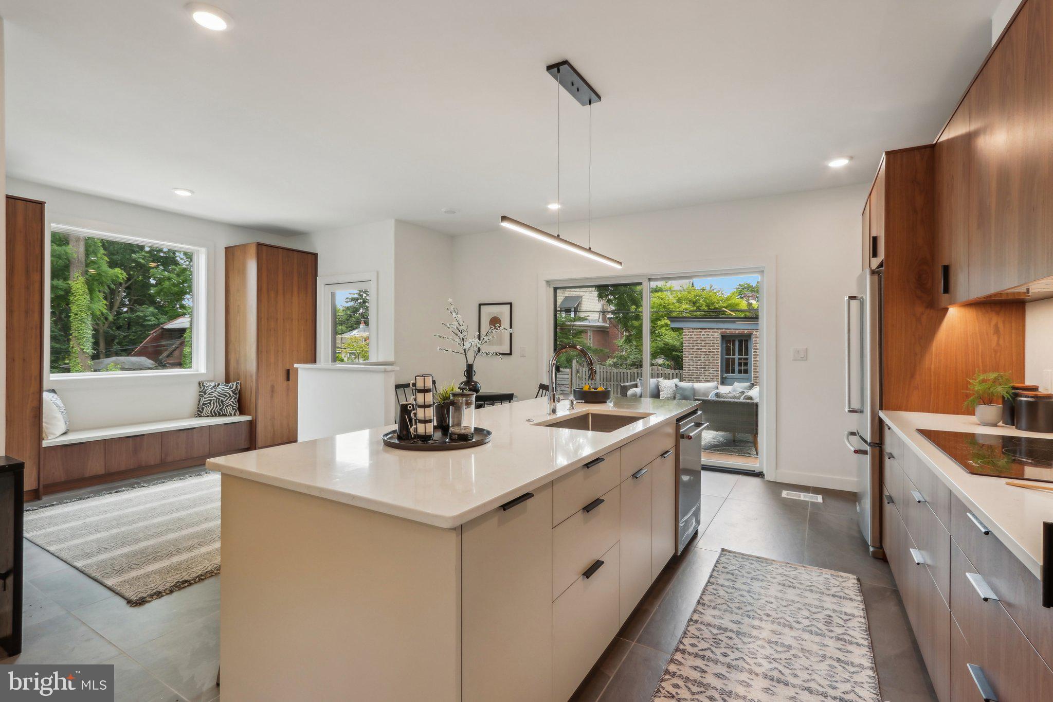 a kitchen with sink stove and refrigerator