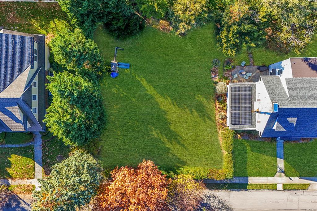 a aerial view of a house with a yard basket ball court and outdoor seating