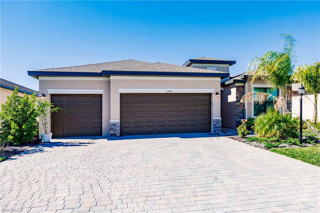 a front view of a house with a yard and garage