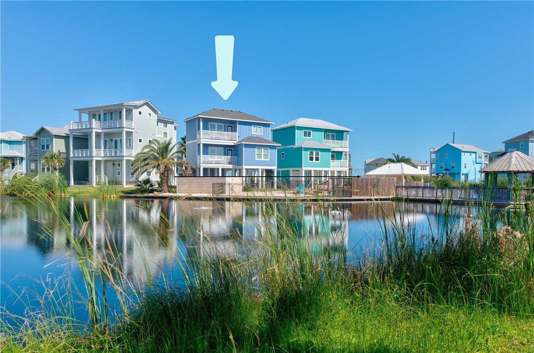 a view of residential house with outdoor space and lake