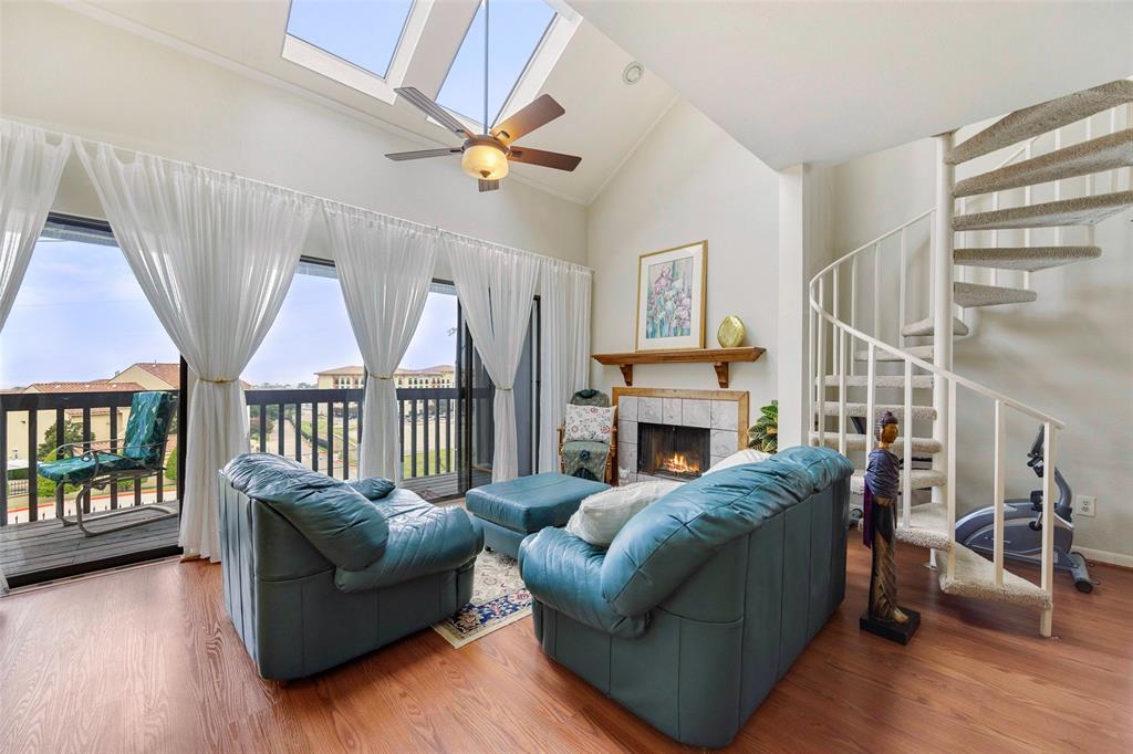 a living room with furniture a fireplace and a window