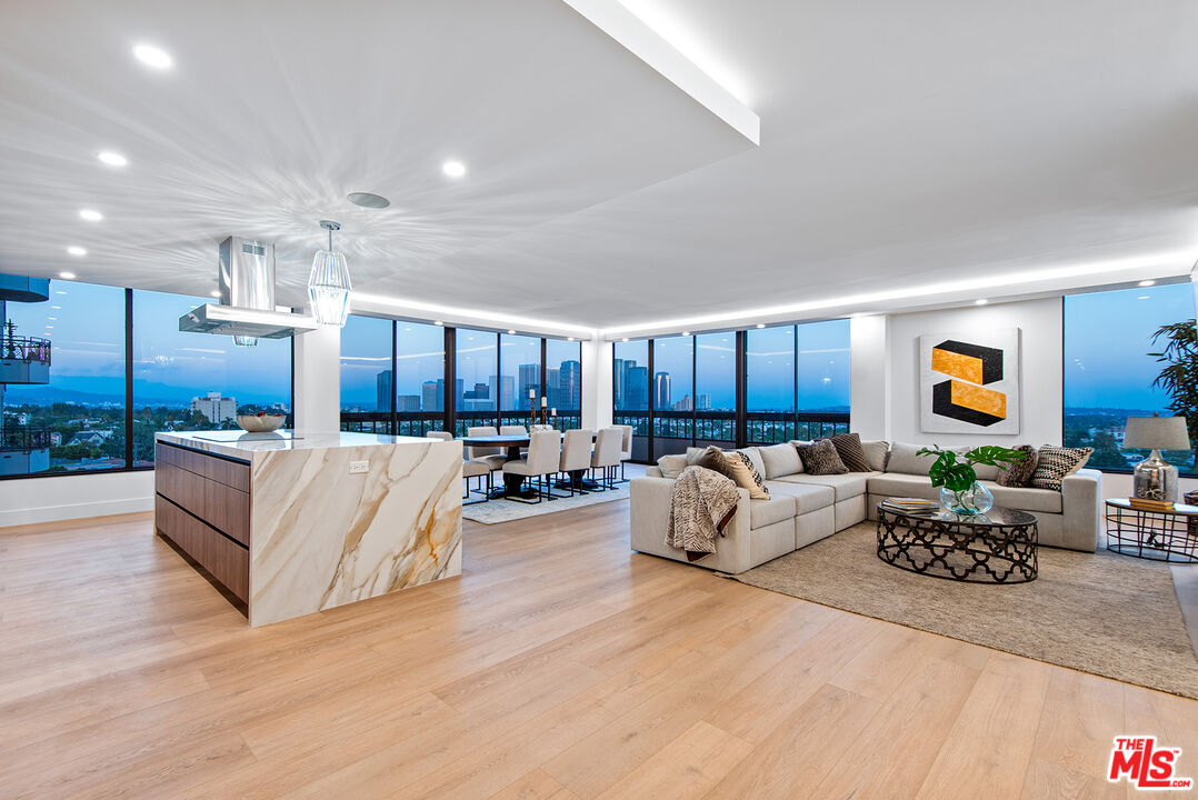 a living room with furniture kitchen and a table