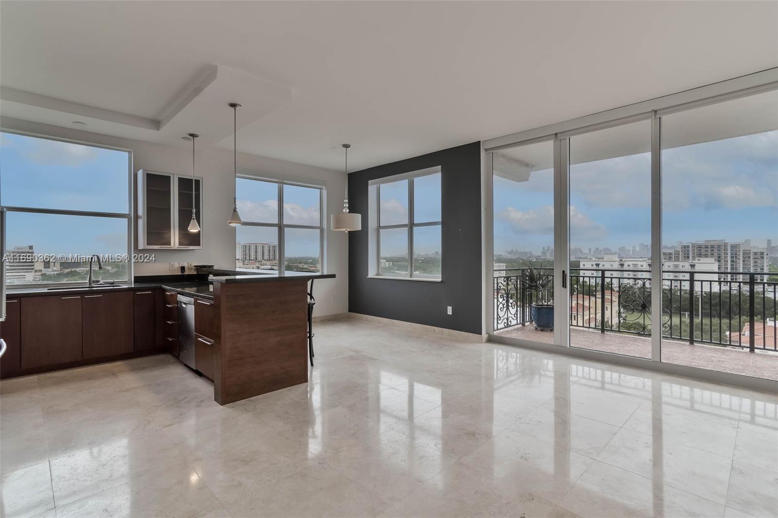 a kitchen with kitchen island granite countertop a refrigerator a sink and cabinets