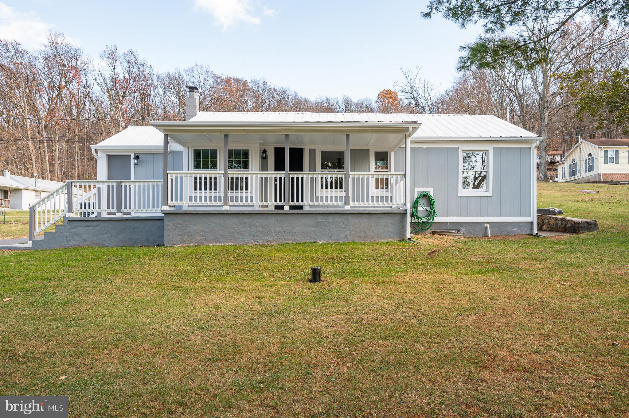 a front view of house with swimming pool and porch