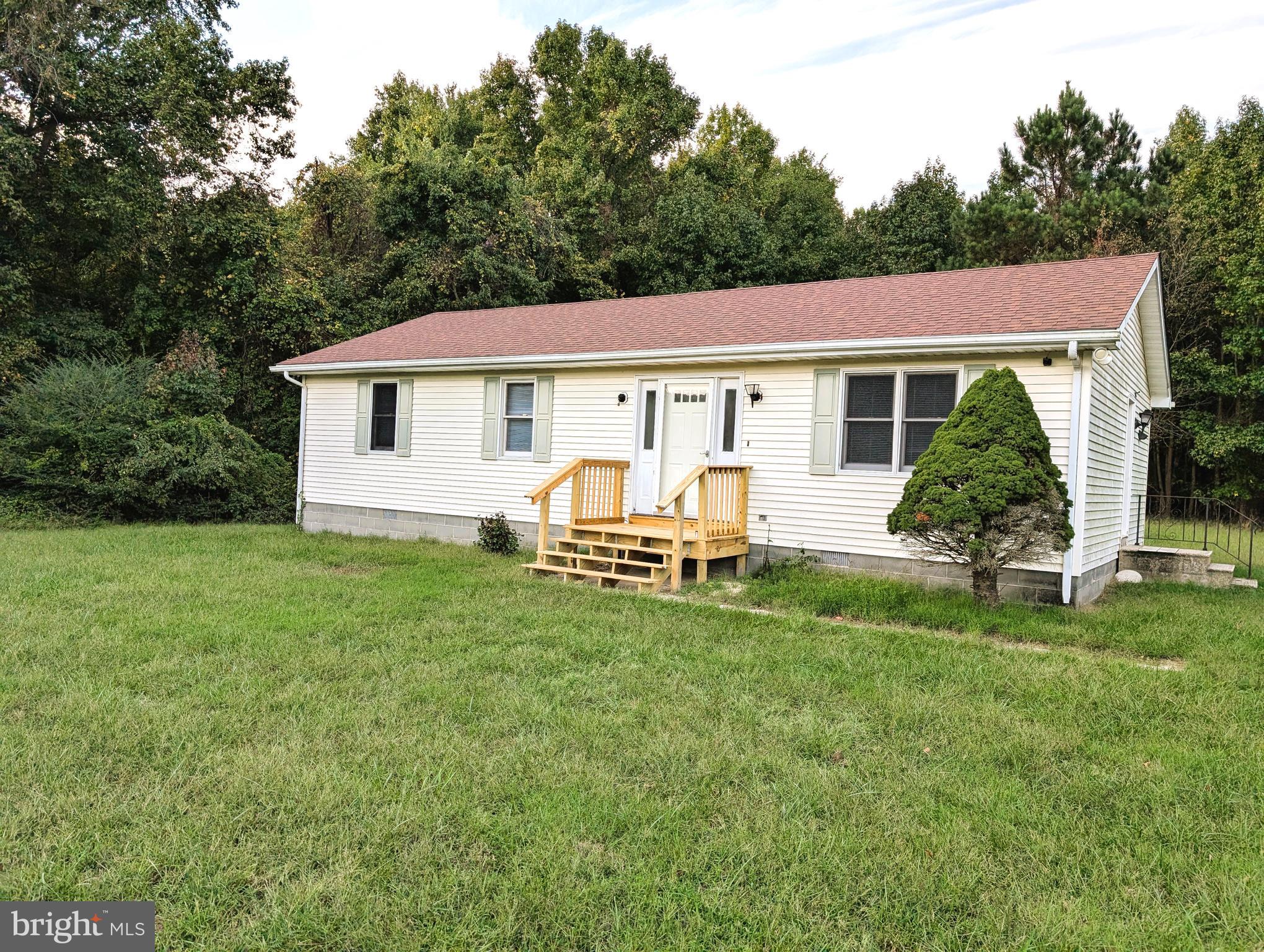 a view of a house with a backyard