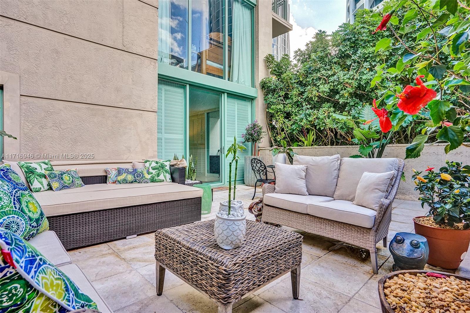 a living room with furniture and a potted plant