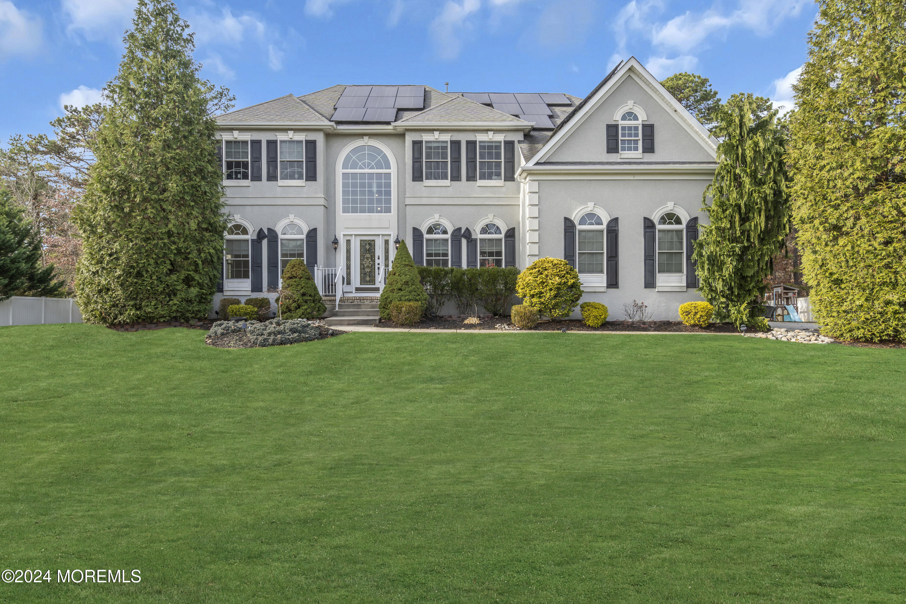 a front view of a house with a yard