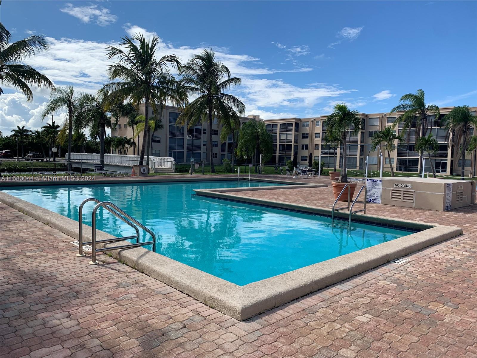 a view of a swimming pool with lounge chair