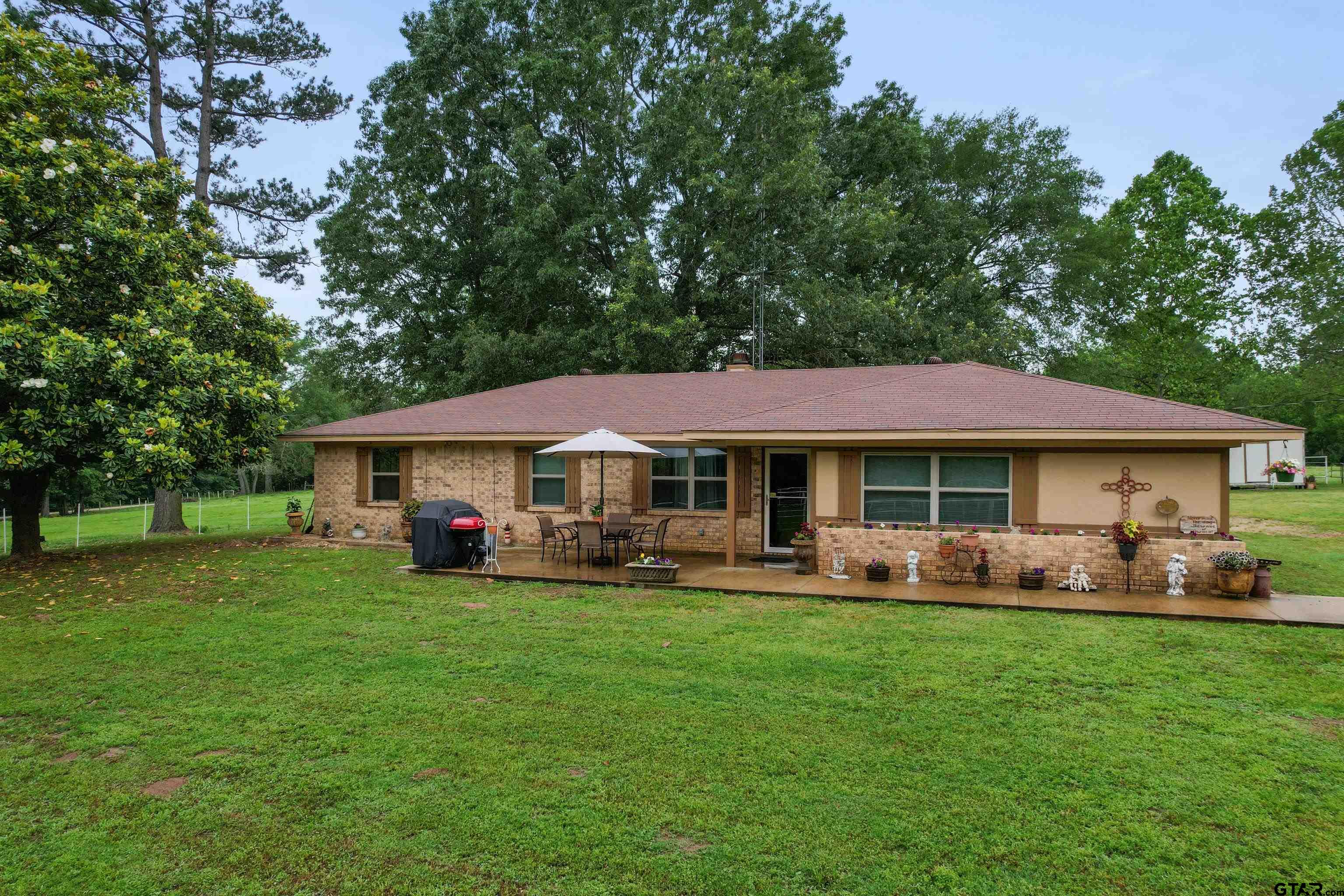 a view of a house with a yard porch and sitting area