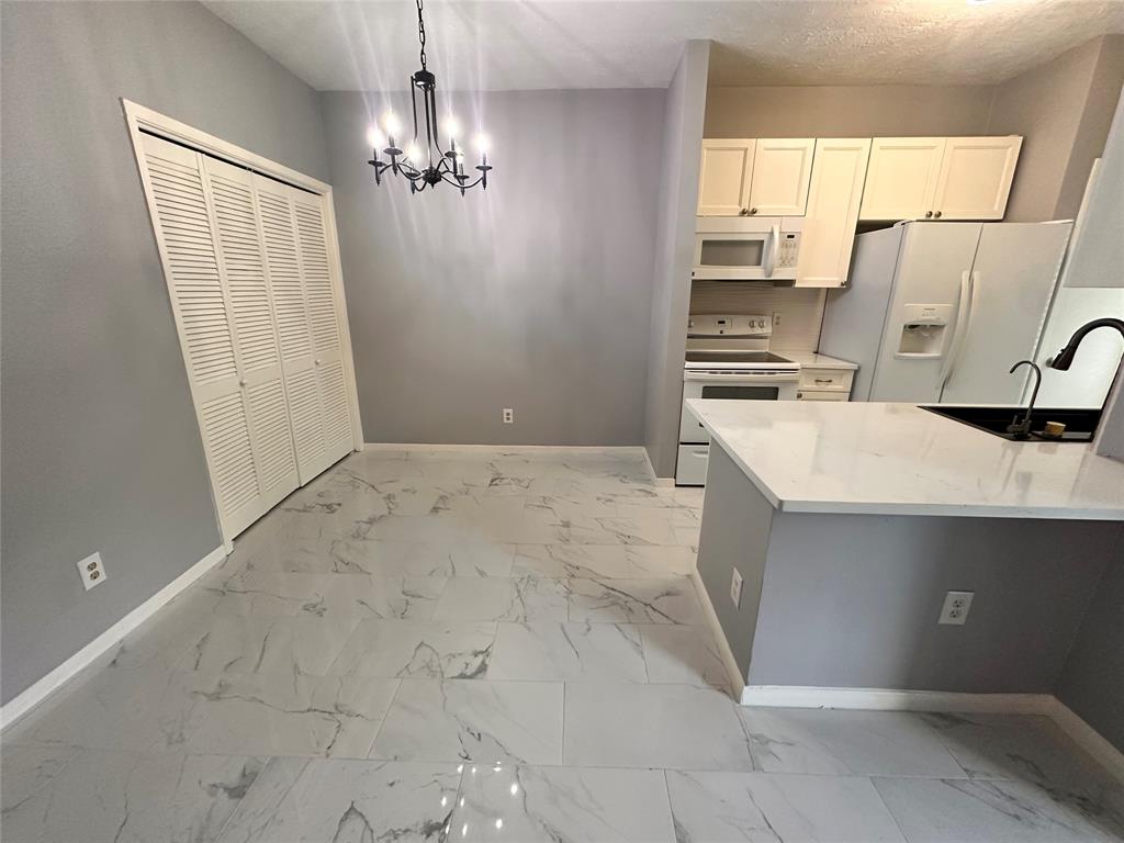 a view of a kitchen with a sink cabinets and a window