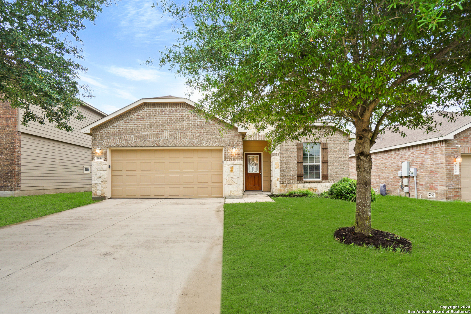 a front view of a house with a yard and garage