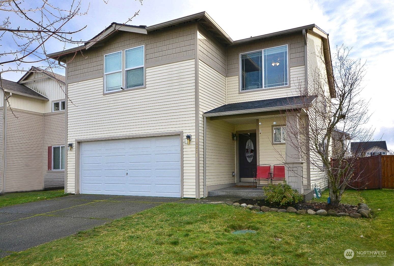 a front view of a house with a yard and garage