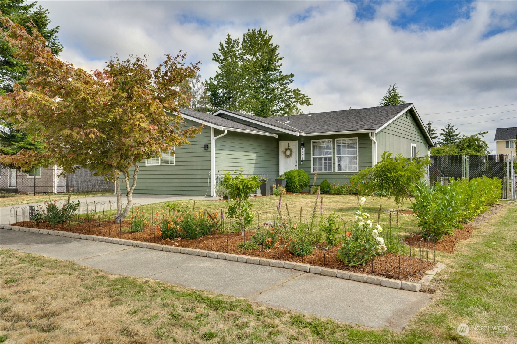 a front view of a house with garden