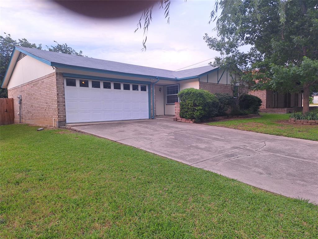 a view of a house with a yard and garage