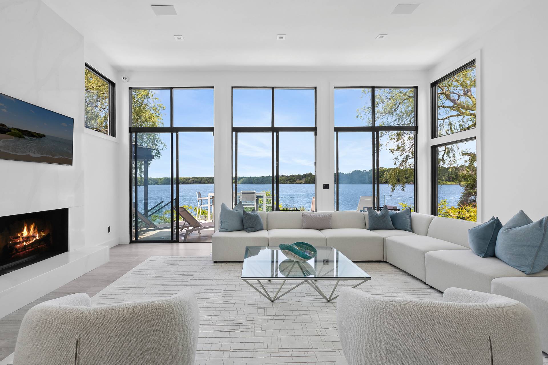 a living room with furniture a flat screen tv and a fireplace