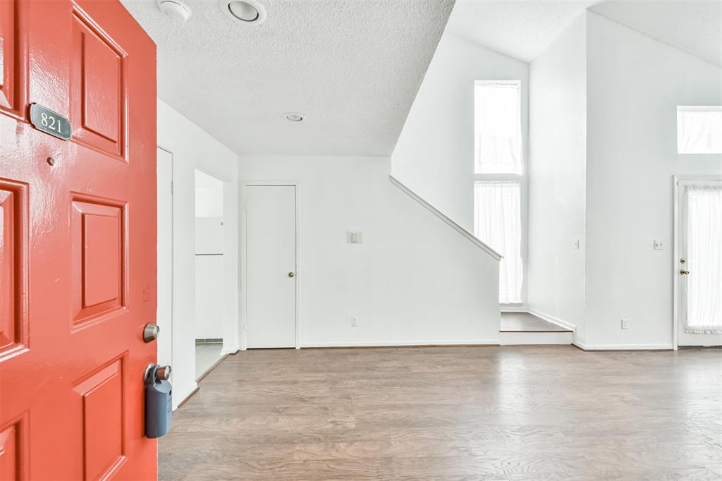 a view of a livingroom with wooden floor and entryway