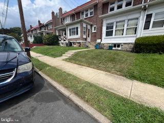 a front view of a house with a yard