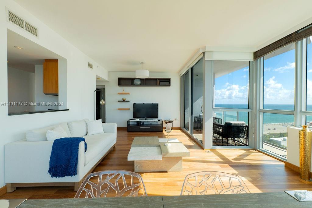 a bedroom with furniture and a large window