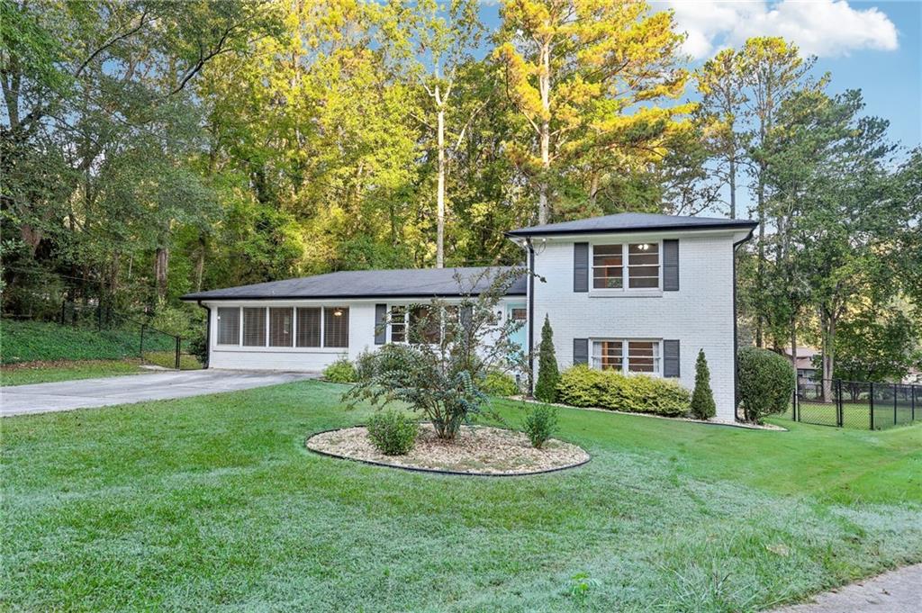 a front view of house with yard and green space