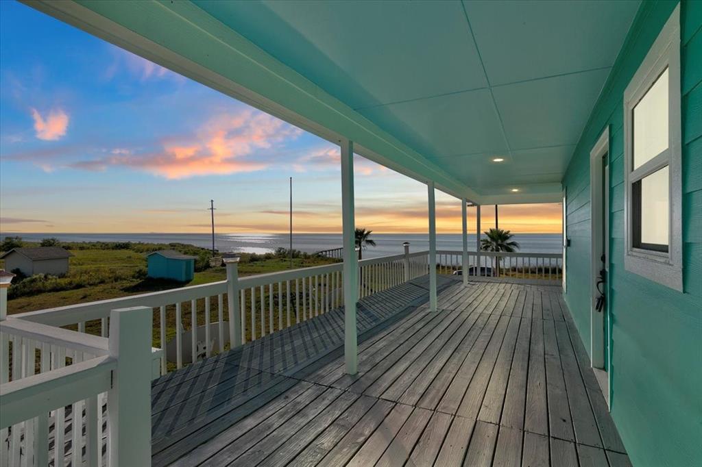 a view of a balcony with wooden floor