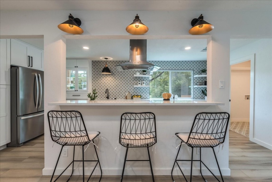 a view of a dining room with chairs and wooden floor