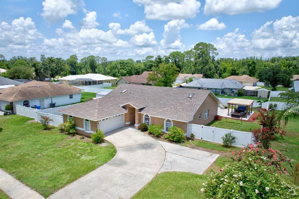 an aerial view of a houses with a garden