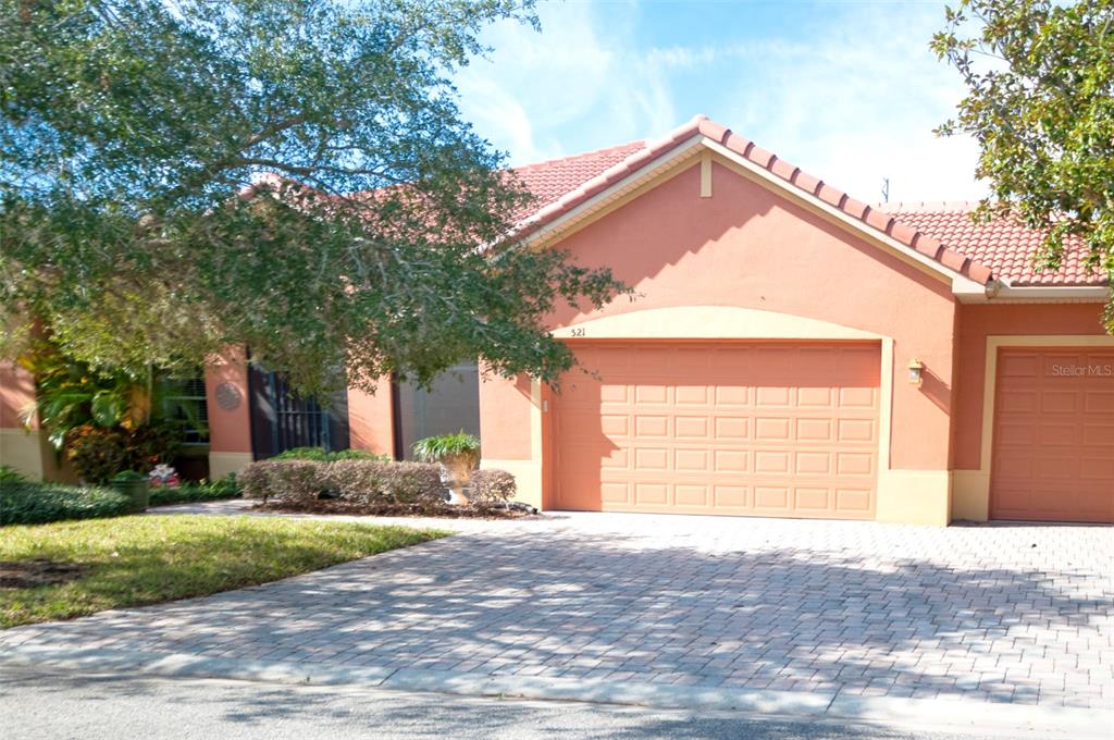 a view of a house with a yard and garage