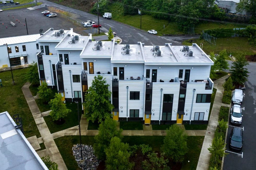 a front view of residential houses with outdoor space and lake view