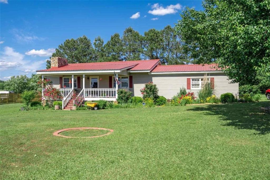 a view of a house with a backyard