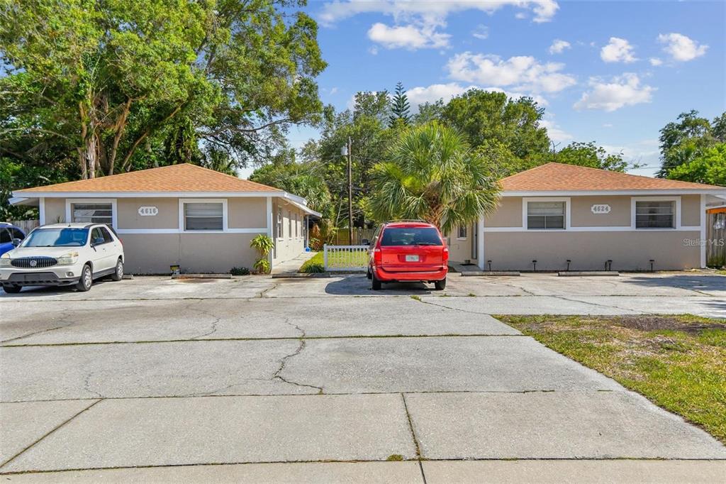 a car parked in front of house with a yard