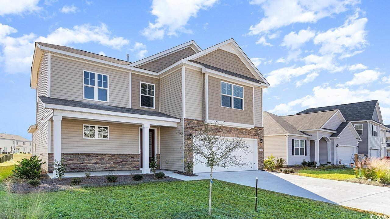 Craftsman house featuring a garage and a front yar