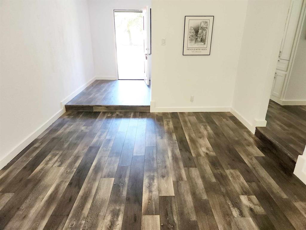 a view of a room with wooden floor